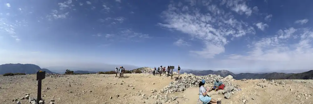 pano of hikers on summit